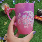 A Pink Galaxy hand painted mug with an elephant zentangle design on it in white and the other side has the name 