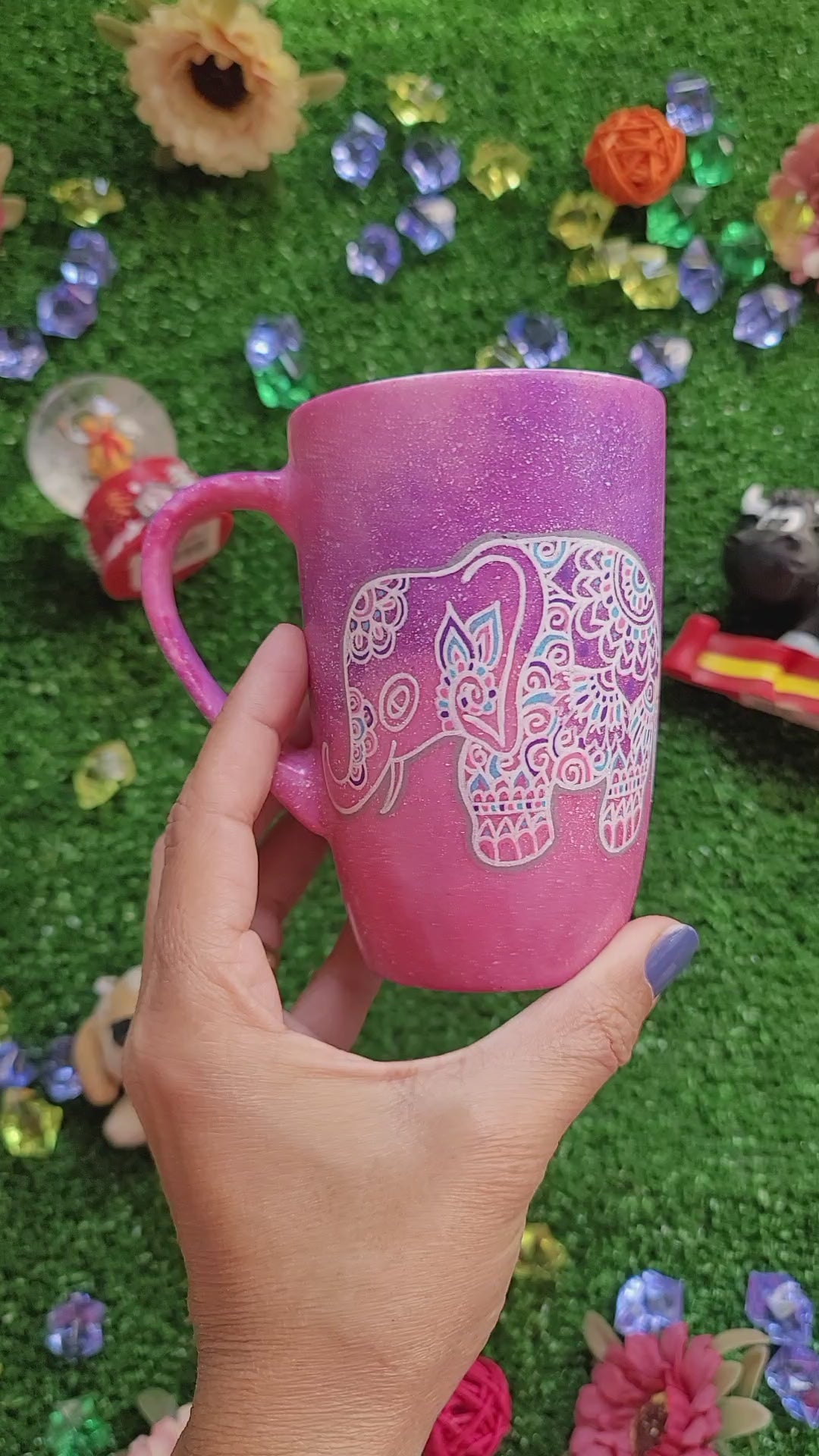 A Pink Galaxy hand painted mug with an elephant zentangle design on it in white and the other side has the name "Eman"