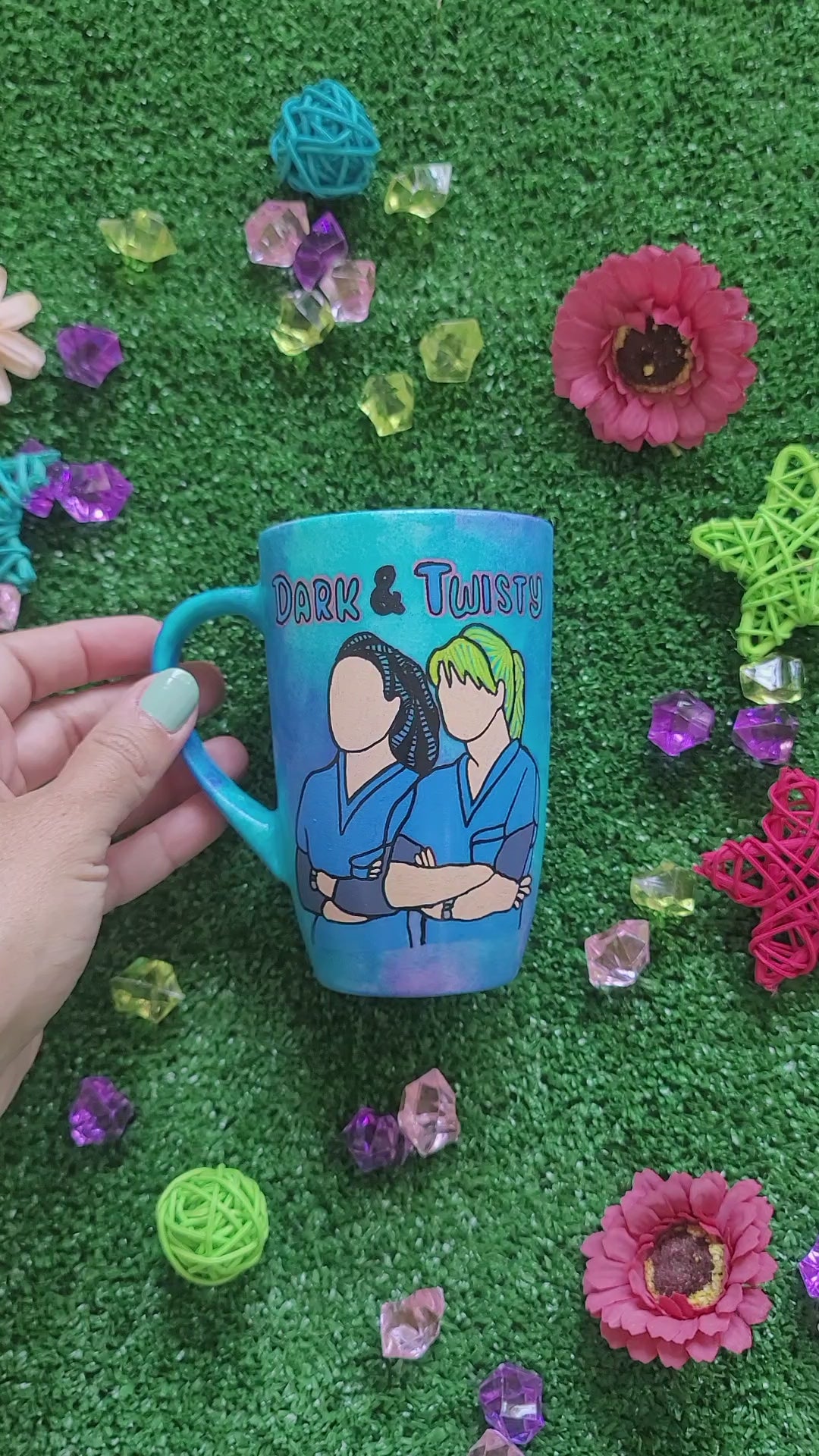 A Blue Hand painted mug with the words "dark and twisty" written on top and a silhouette of 2 girls in medical coats and the other side has the name "sadeem"