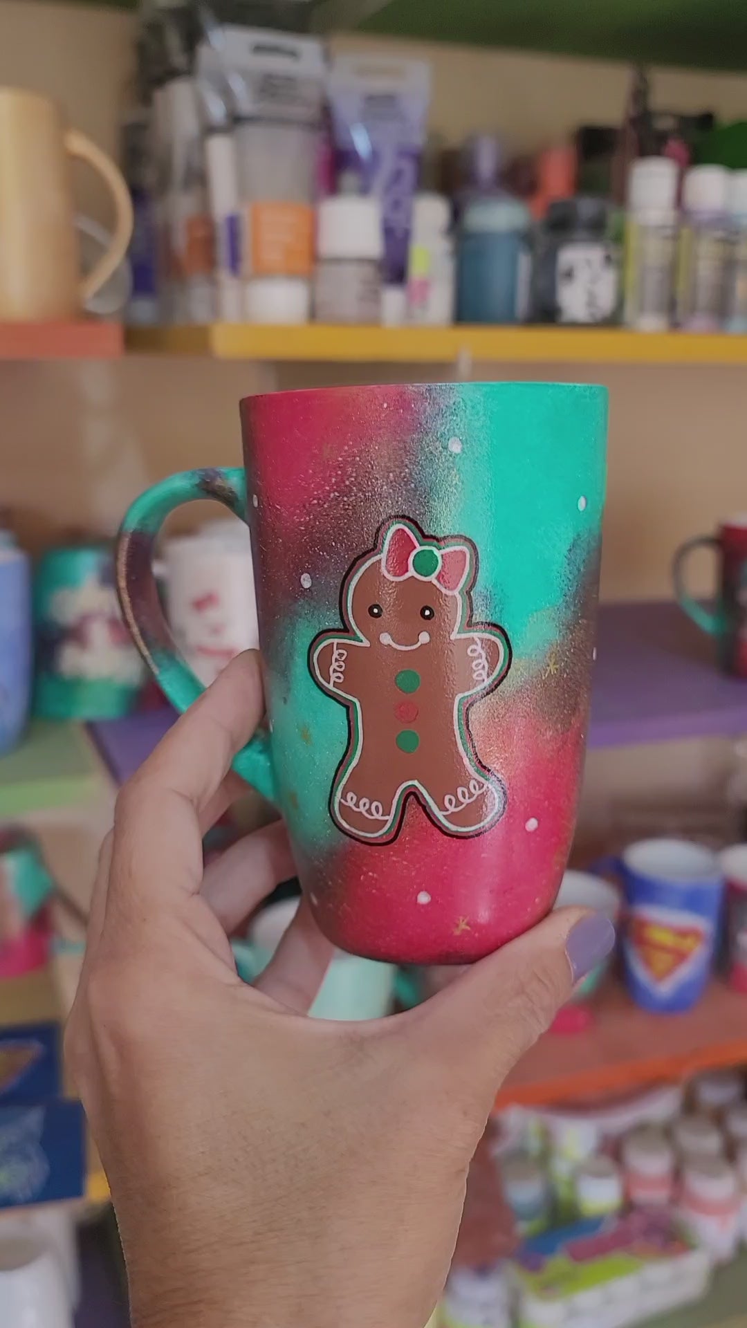 A Christmas hand painted mug with aa gingerbread cookie girl on it with a bow and the other side has the name "Salomaty"