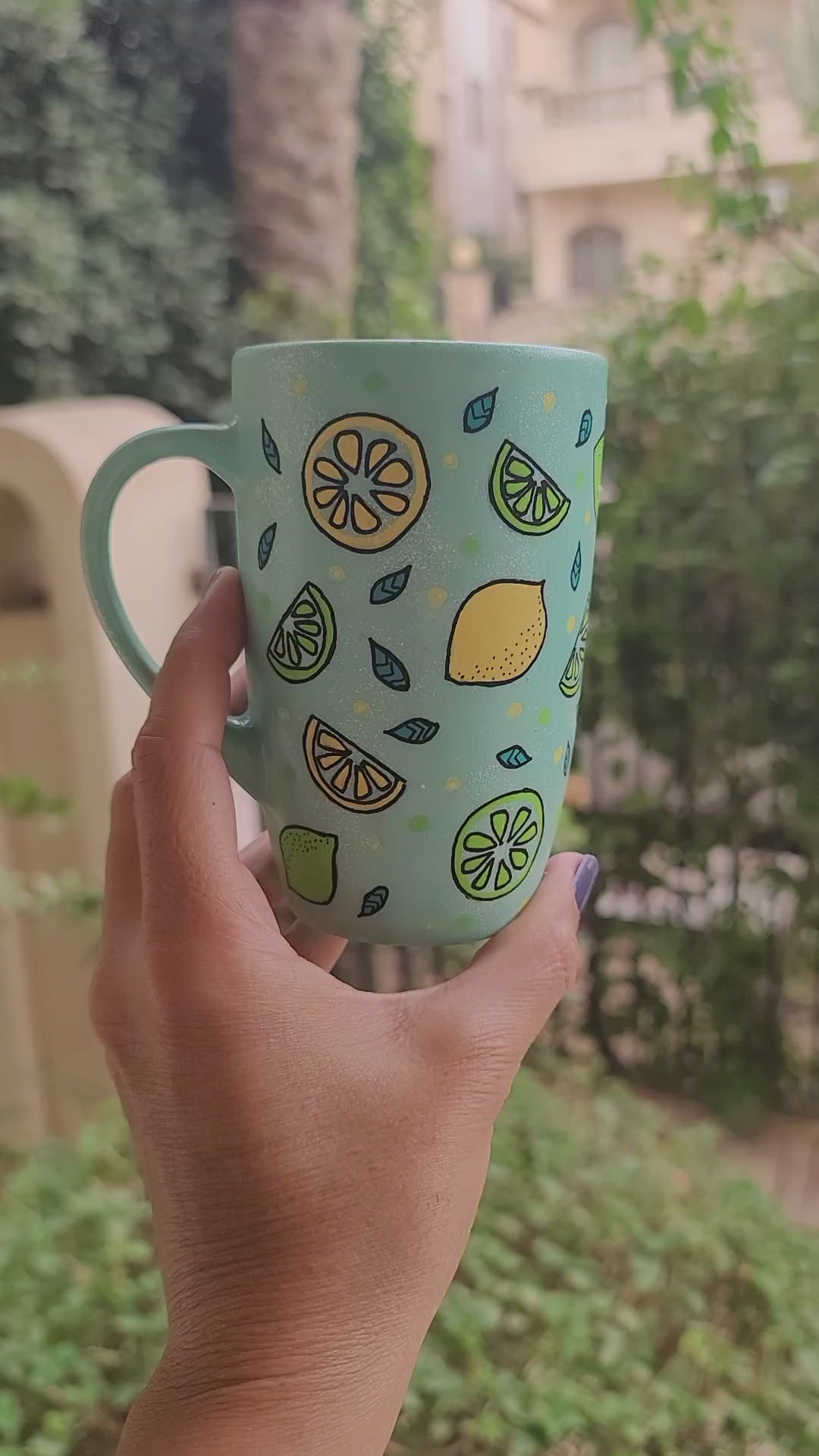 A Mint Green mug with lemons scattered all over