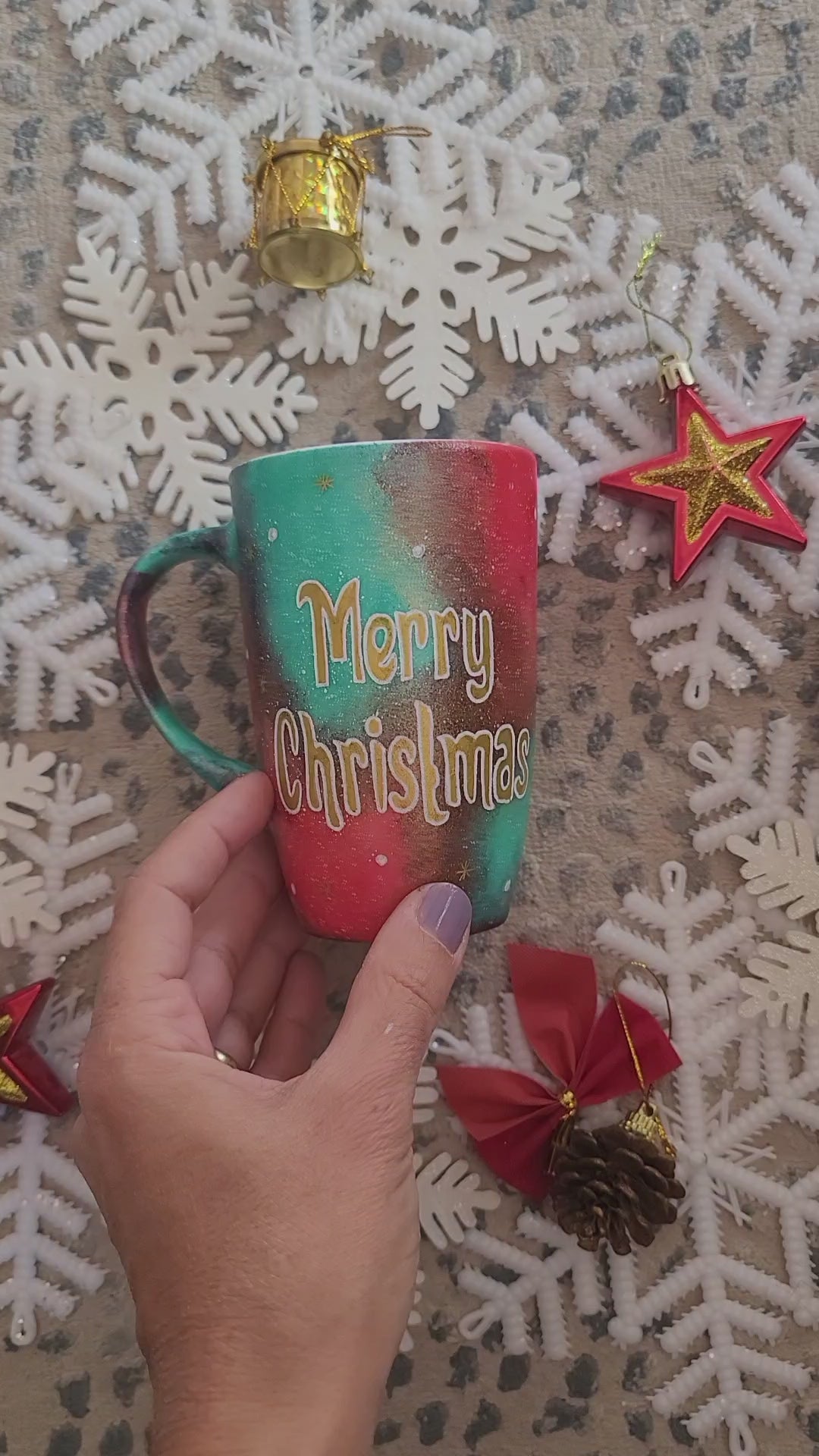 A Christmas galaxy colored hand painted mug with the words "Merry Christmas" written gold with white dots and gold stars scattered all over and the other side has the name sally