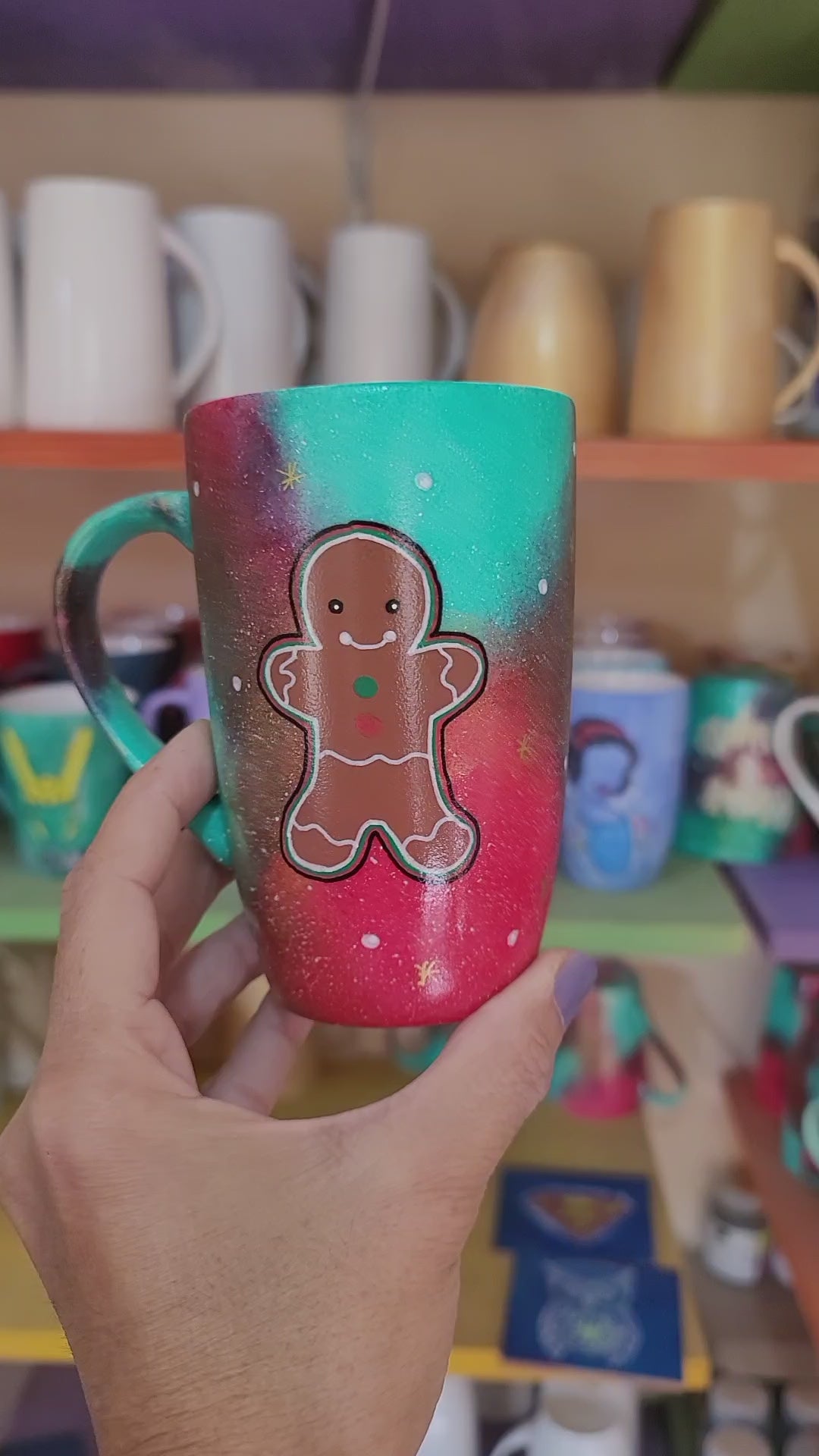 a christmas colored hand painted mug with a gingerbread cookie boy painted on it and the other side has the name Zoza