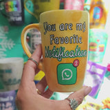 A yellow orange hand-painted mug with the words 