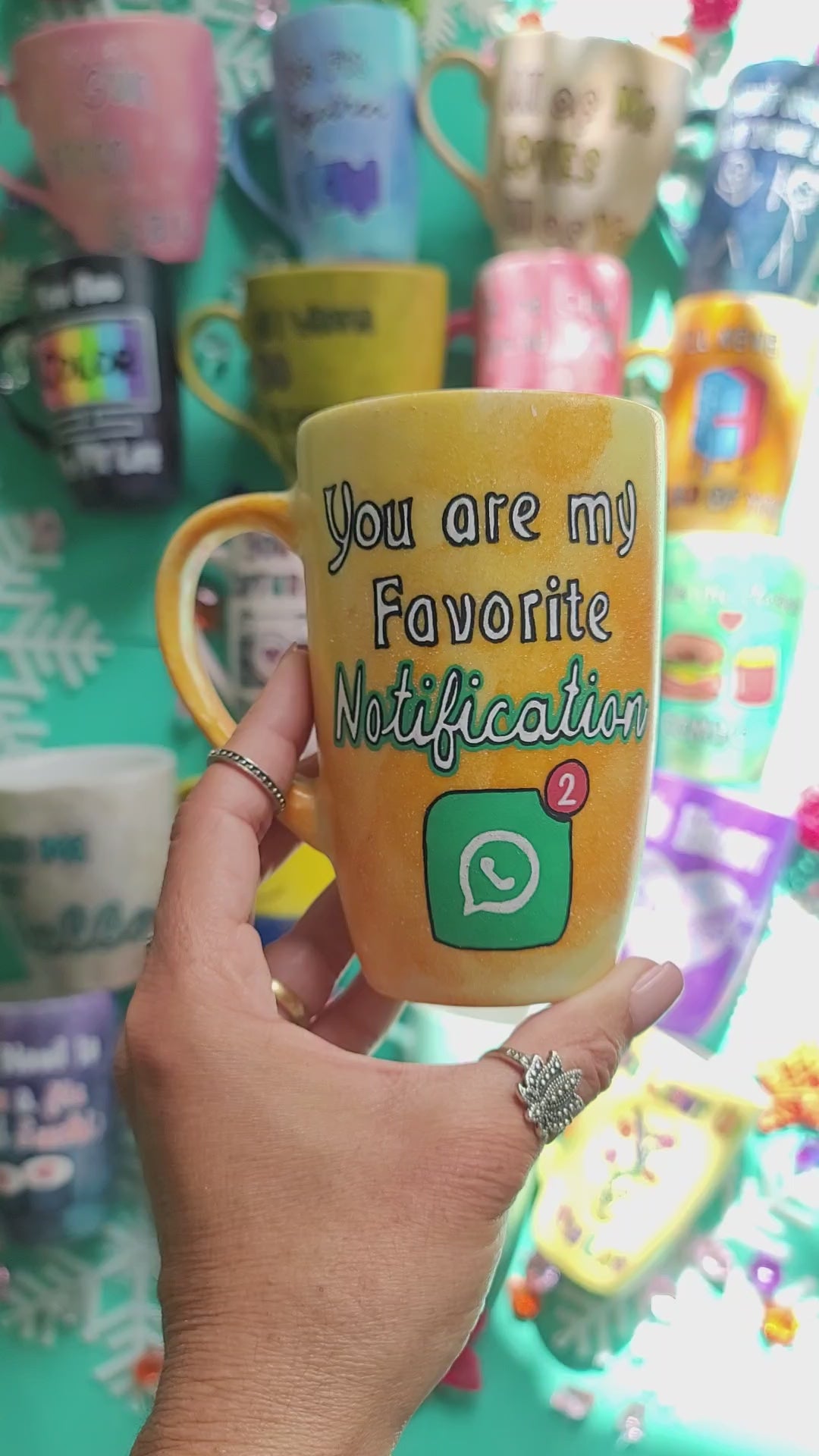 A yellow orange hand-painted mug with the words "You are my favorite notification". and on the other side the name "Aya"