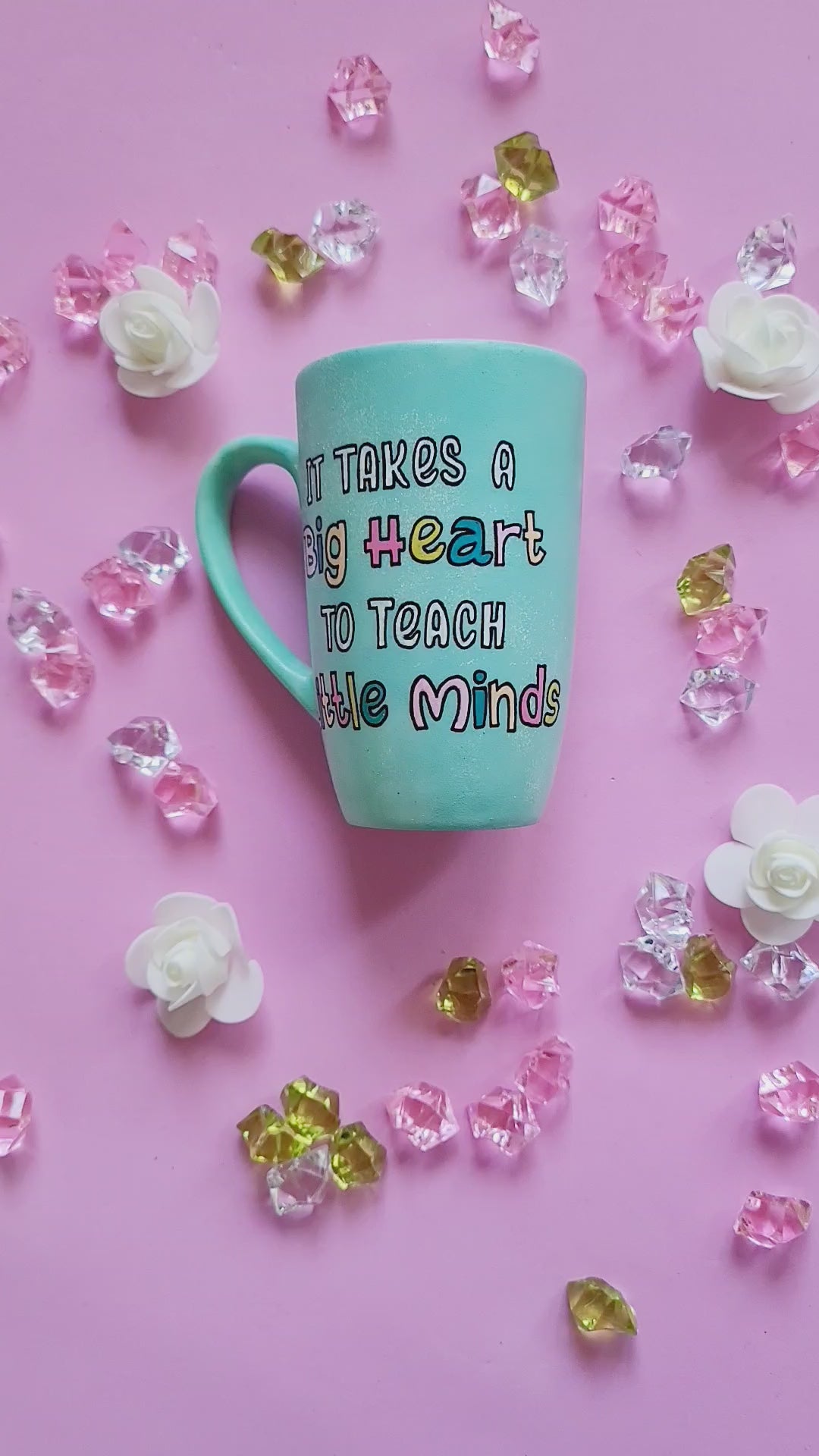 A Mint green handpainted mug with the words "its takes a big heart to teach little minds" and the other side has the name "Nihal"