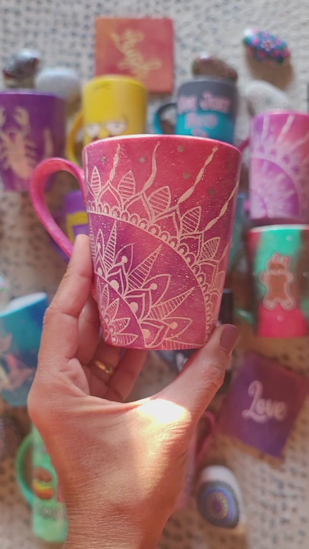 A hand-painted pink galaxy mug with a quarter mandala drawn in the corner and the word together on the other side in silver and white outline