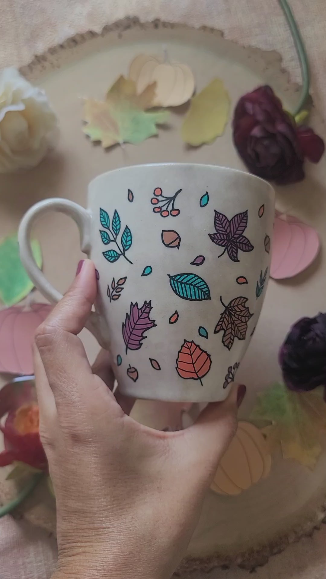 A Taupe Hand painted mug with autumn leaves scattered all over