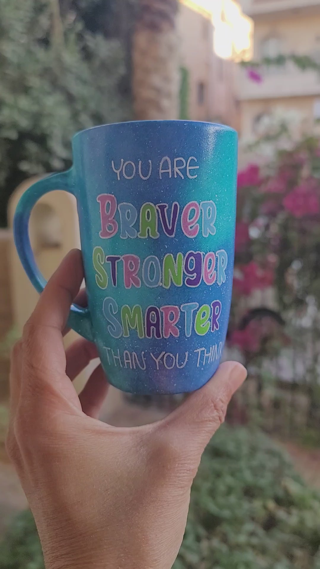 A Blue Galaxy Mug with the words "You are Braver, Stronger, Smarter than you think" and the other side has the name "Leila"