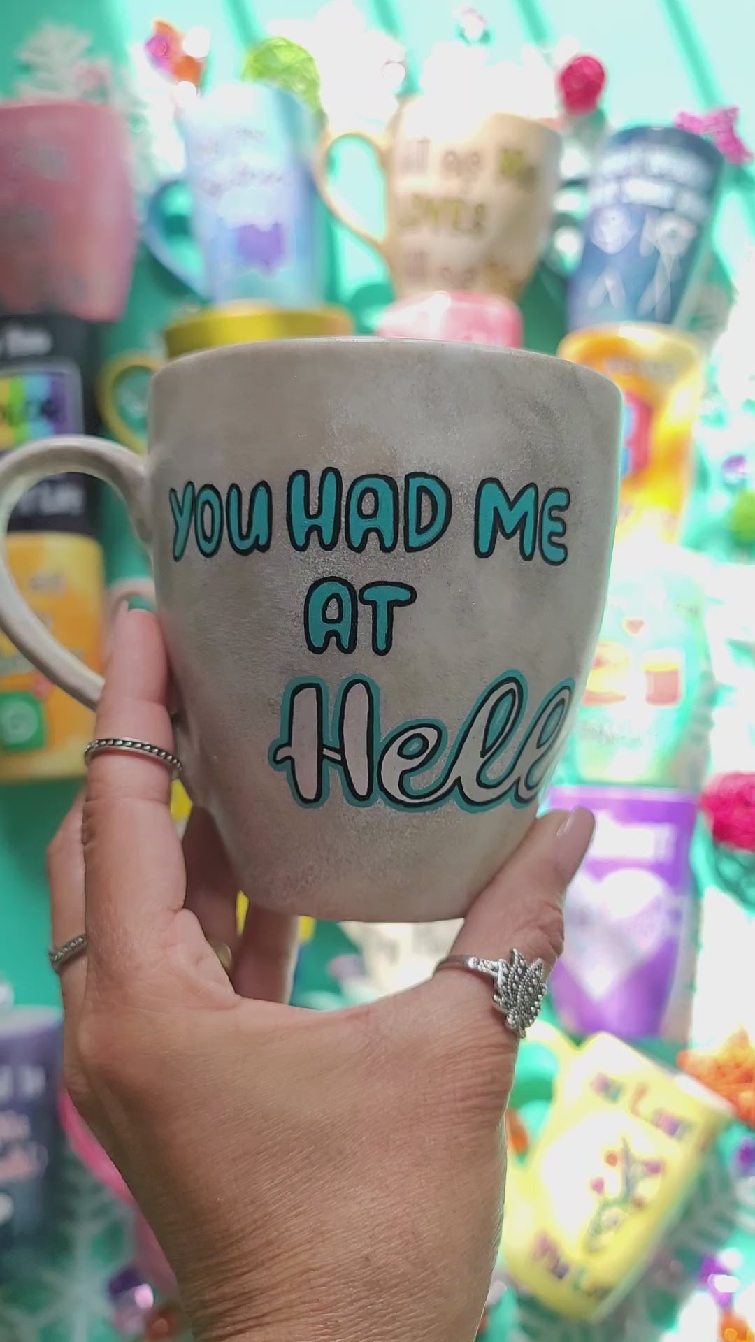 A hand-painted taupe silver mug with the words "You had me at hello" and the name "Hatem" on the other side