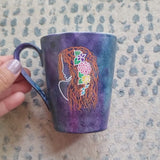 A video showing a dark sky colored mug with Virgo on one side and the name 