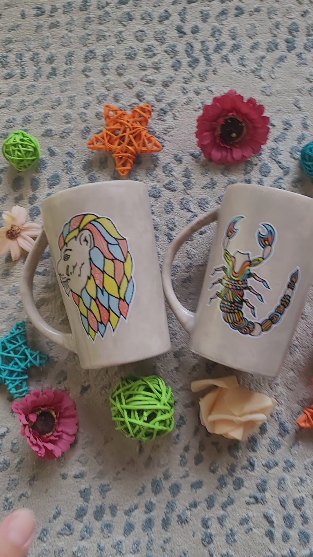 2 hand-painted taupe mugs, one with the scoprio sign on one side and the words "Nour the queen" on the other, and the other has a leo sign on one side and the words "Tarek the king" on the other