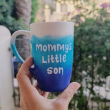 A Gradient hand painted mug with the colors (White turquoise and ultramarine) with the words 