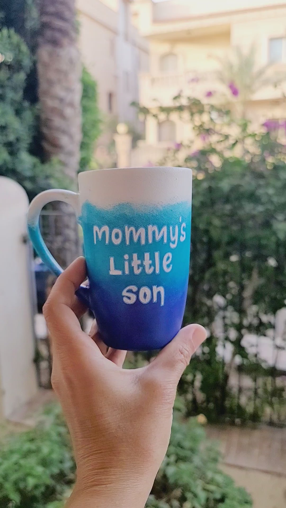 A Gradient hand painted mug with the colors (White turquoise and ultramarine) with the words "mommy's little son" and the other side has the name "Kiko"