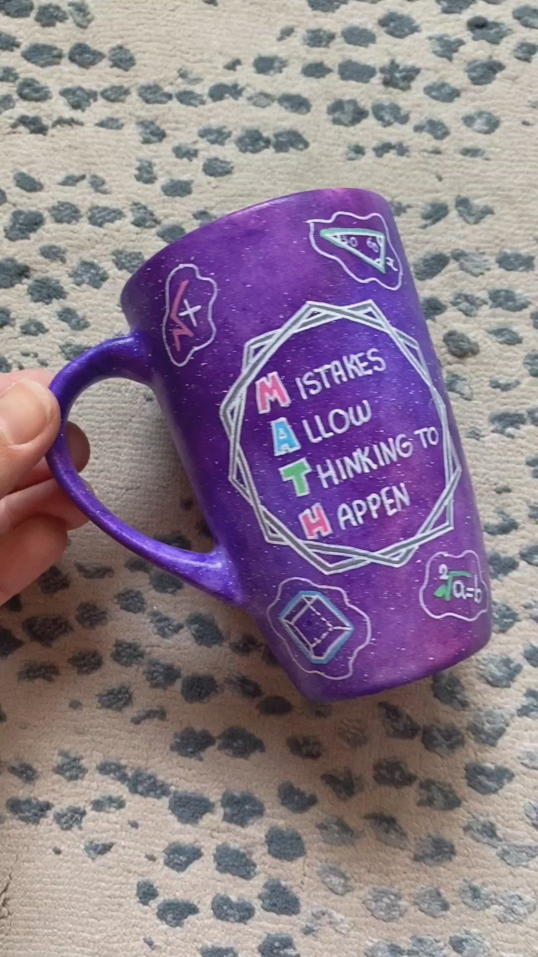 A Purple Galaxy Hand painted mug with the words "Mistakes Allow Thinking to happen" and math icons scattered all over  and the other side has the name "Sarah"