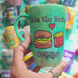 A hand-painted green galaxy mug with the words 