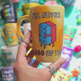 A yellow orange hand-painted mug with the words 