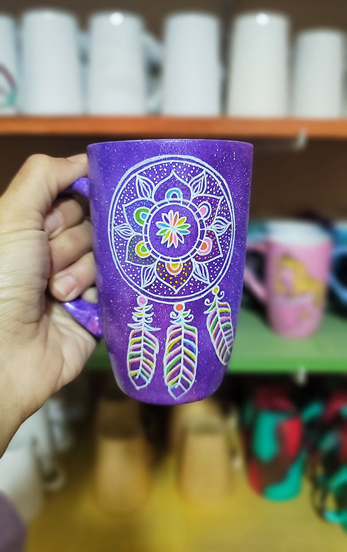 A Purple Galaxy hand painted mug with a dreamcatcher in white and colored in with (pink, yellow, purple blue, green and orange)