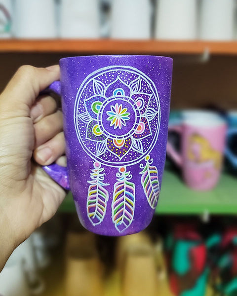 A Purple Galaxy hand painted mug with a dreamcatcher in white and colored in with (pink, yellow, purple blue, green and orange)