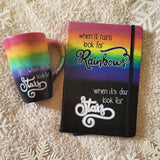 A Mug with the top half painted in rainbow and the bottom in dark galaxy, with the words on the dark galaxy 