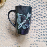 a hand-painted black galaxy mug with a Sagittarius sign