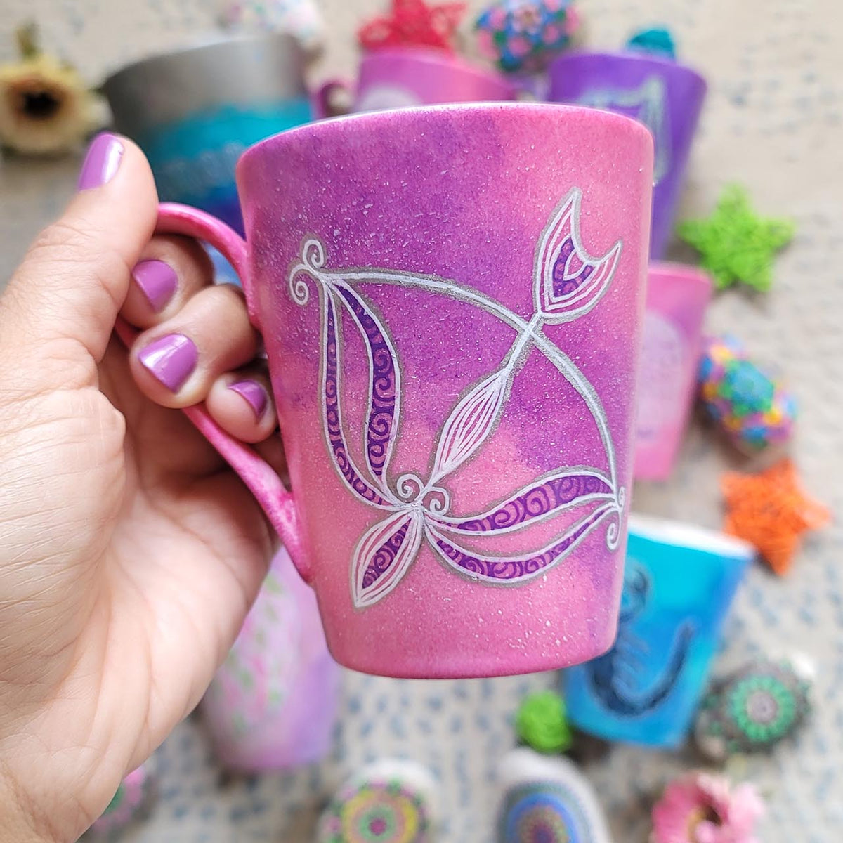 a hand-painted pink galaxy mug with a Sagittarius sign