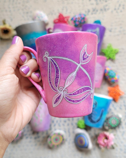 a hand-painted pink galaxy mug with a Sagittarius sign