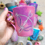 a hand-painted pink galaxy mug with a Sagittarius sign