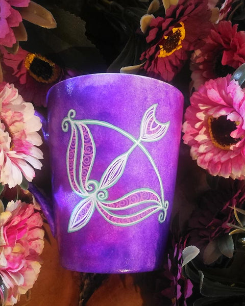 a hand-painted purple mug with a Sagittarius sign