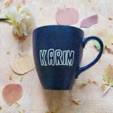 A bLuish Galaxy hand painted mug with the name 