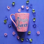 a shimmery pink hand paitned mug with teh words shopping queen written in white a shimmery blue. with blue and white dots scattered all over the mug