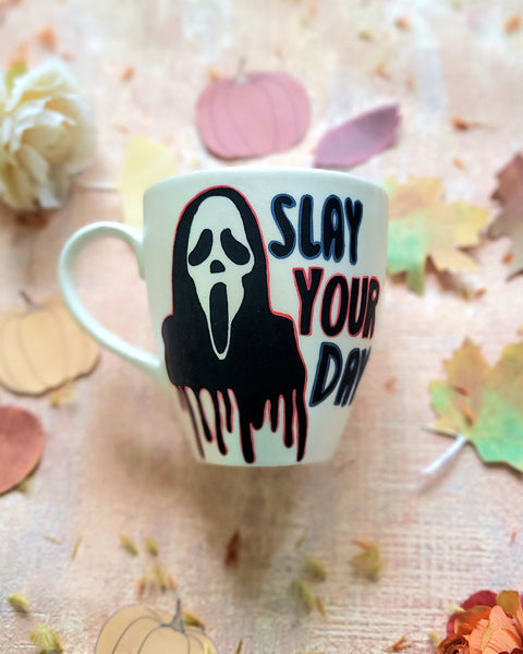 An Ivory hand painted mug with the word "slay your day"