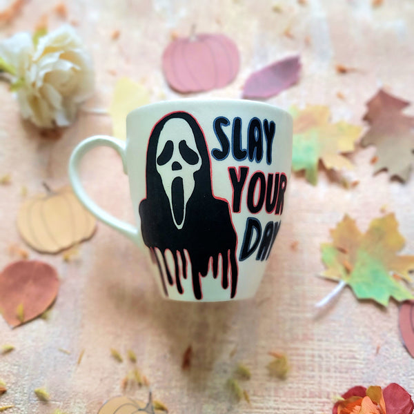 An Ivory hand painted mug with the word "slay your day"