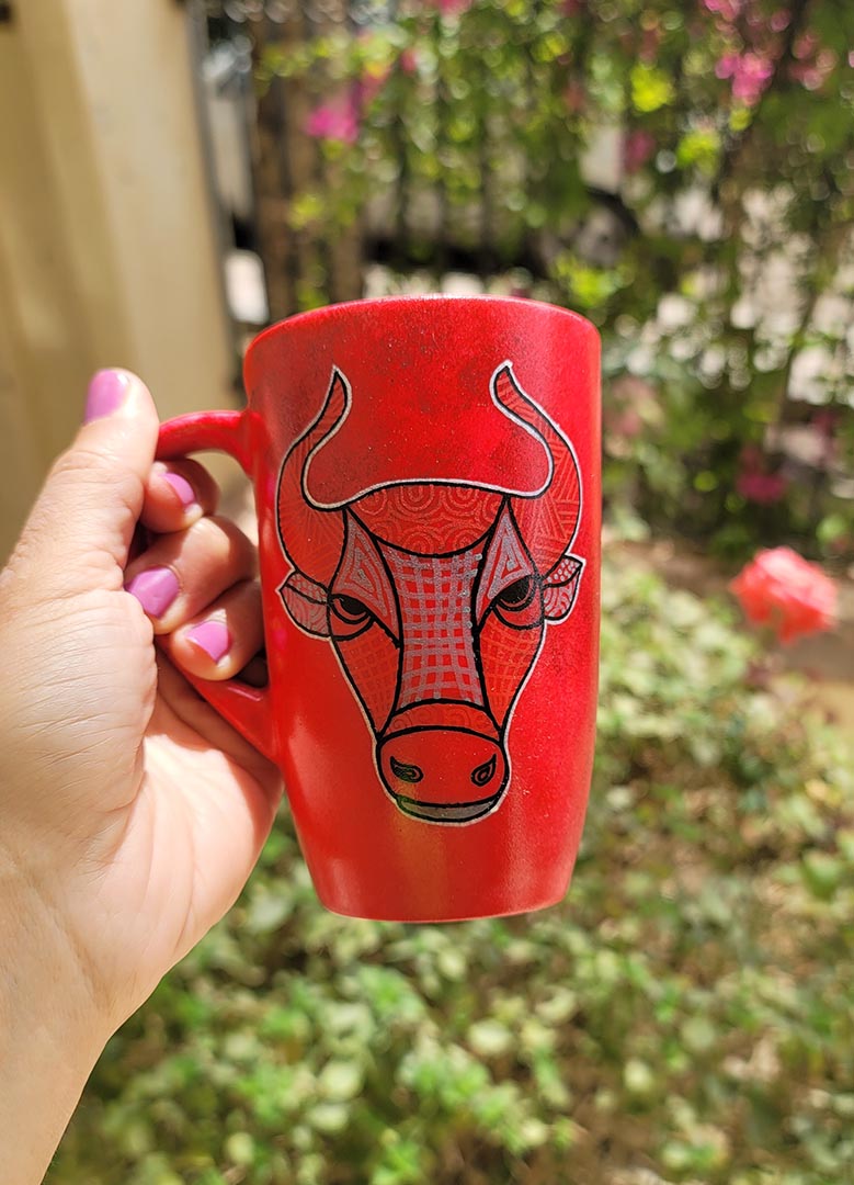 A hand-painted red black mug with Taurus sign