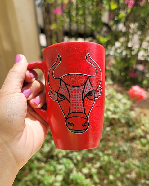 A hand-painted red black mug with Taurus sign