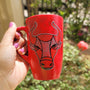 A hand-painted red black mug with Taurus sign