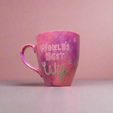 A Hand painted pink galaxy mug with the sentence 