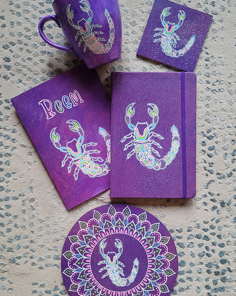 A Purple hand painted gift set (mug, notebook, coaster, card, wood plate ) all with the Scorpio sign and the name reem